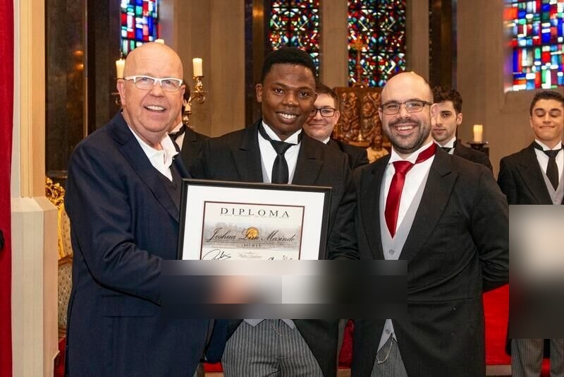 LIRU J. MASINDE receiving his diploma certificate at The International Butler Academy